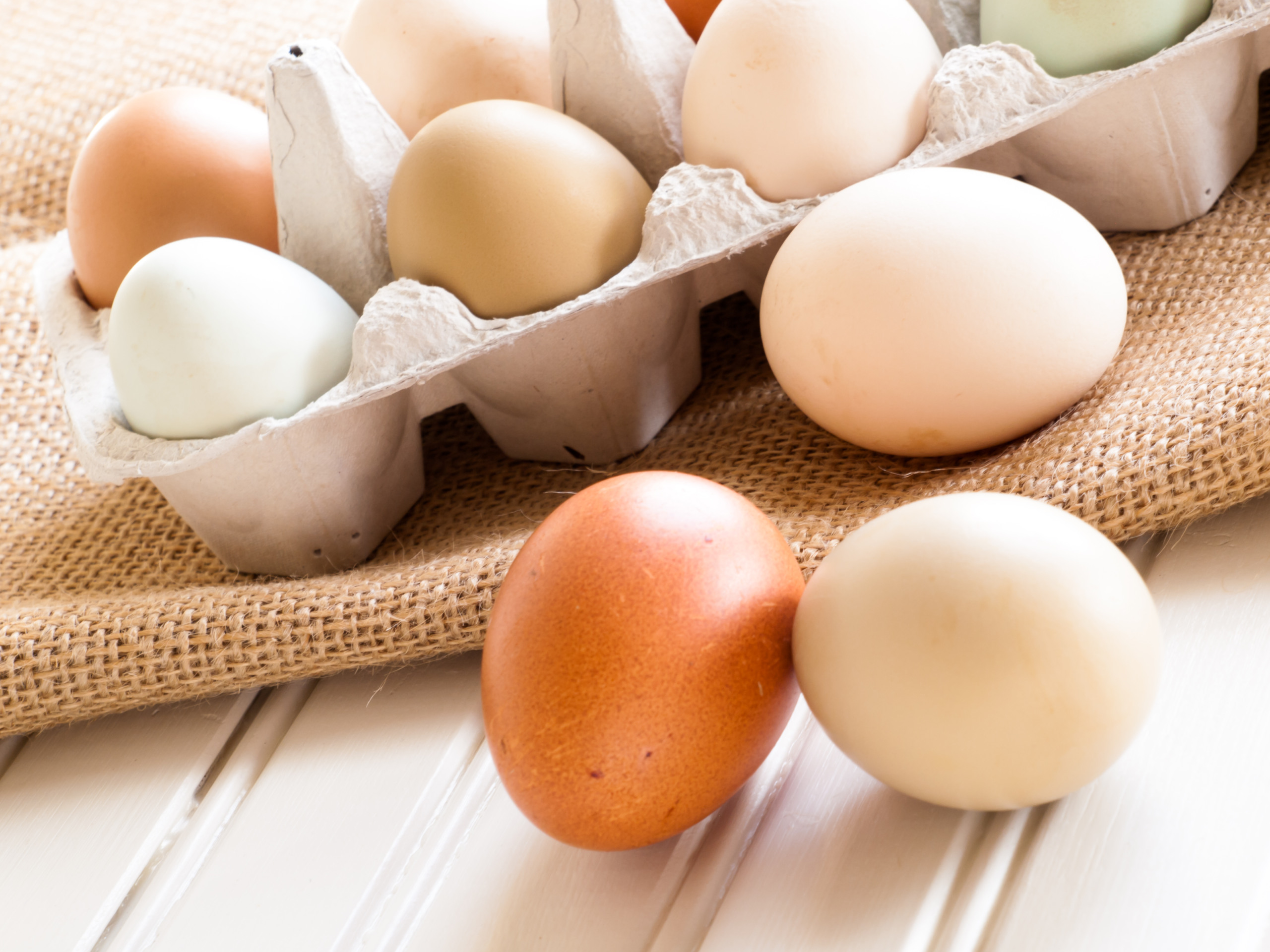 Fresh multi-color farm eggs on the table.